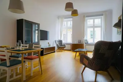 a living room with a dining table and chairs at lux Floriańska in Kraków