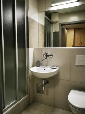 a bathroom with a sink and a toilet at Dom Studencki Zaułek in Kraków