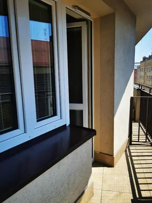 a balcony of a building with two windows at Dom Studencki Zaułek in Kraków