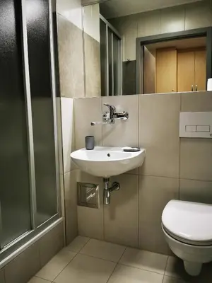 a bathroom with a sink and a toilet at Dom Studencki Zaułek in Kraków