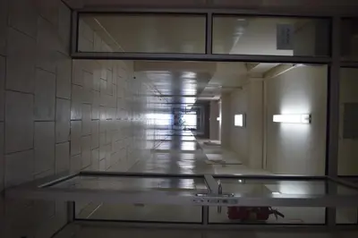 a view through a glass window of a hallway at Dom Studencki Atol in Kraków