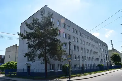 a large white building on the side of a street at Dom Studencki Atol in Kraków