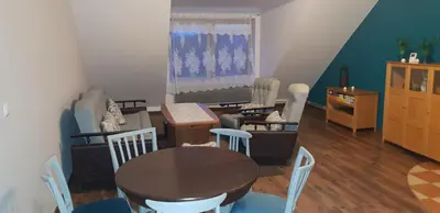 a living room with a table and chairs at Guzikowa Chata in Dobczyce