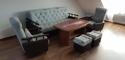 a living room with a couch and a table and chairs at Guzikowa Chata in Dobczyce