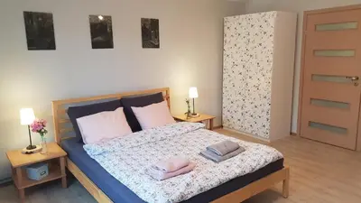 a bedroom with a bed with two towels on it at Guzikowa Chata in Dobczyce