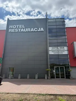 a hotel with a sign on the side of a building at Mark1 in Brzesko
