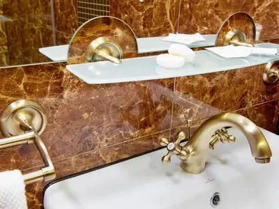 a bathroom with two sinks and two mirrors at Pokoje Leonardo in Kraków