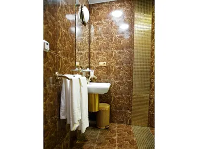 a bathroom with a sink and a shower at Pokoje Leonardo in Kraków