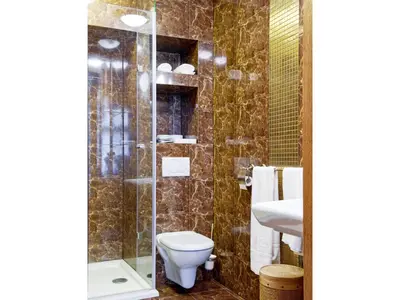 a bathroom with a toilet and a sink and a shower at Pokoje Leonardo in Kraków