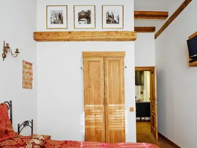 a room with a wooden door and some pictures on the wall at Pokoje Leonardo in Kraków