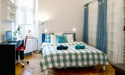a bedroom with a bed with a desk and a computer at Large and cozy Apartment 60 m2, Cracow Old Town in Kraków