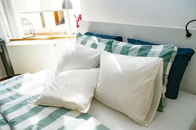 a pile of pillows on a bed in a room at Large and cozy Apartment 60 m2, Cracow Old Town in Kraków