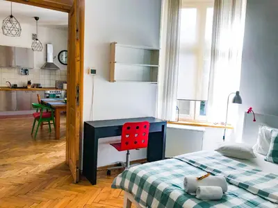 a bedroom with a bed and a red desk at Large and cozy Apartment 60 m2, Cracow Old Town in Kraków