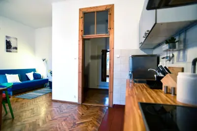 a kitchen and living room with a blue couch at Large and cozy Apartment 60 m2, Cracow Old Town in Kraków