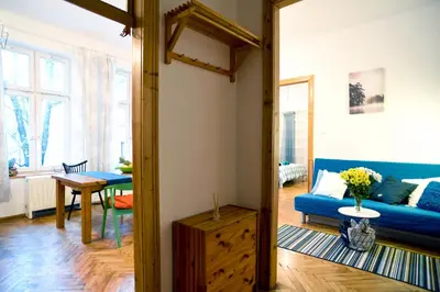 a living room with a blue couch and a table at Large and cozy Apartment 60 m2, Cracow Old Town in Kraków