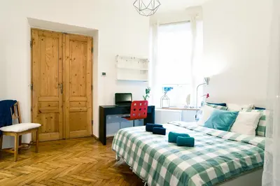 a bedroom with a bed and a desk and a window at Large and cozy Apartment 60 m2, Cracow Old Town in Kraków