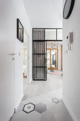 an open living room with a large glass door at City of the Kings - Pastel Apartment Lubelska 10 in Kraków