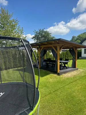a gazebo and a picnic table in a yard at Dom Wypoczynkowy przy Szlaku OJCÓW in Ojców
