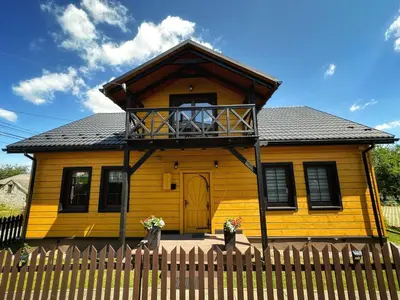 a yellow house with a balcony on top of it at Dom Wypoczynkowy przy Szlaku OJCÓW in Ojców