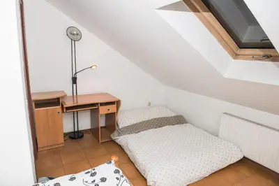 a small room with a desk and a bed at Parkowa House in Kraków