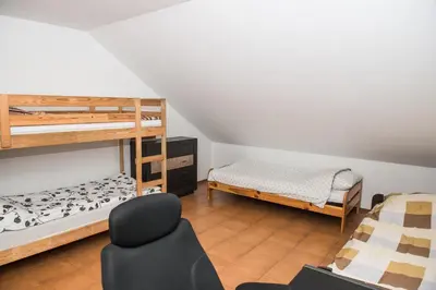 a room with two bunk beds and a chair at Parkowa House in Kraków