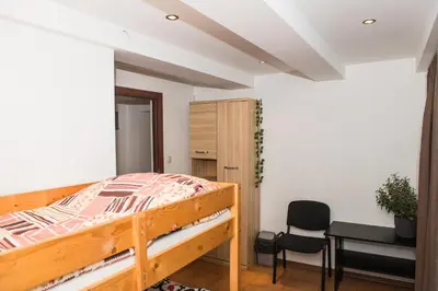 a bedroom with a bed and a desk and a chair at Parkowa House in Kraków