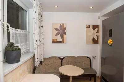 a room with a table and a chair and a window at Parkowa House in Kraków