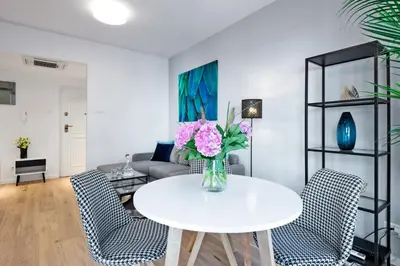 a living room with a white table and chairs at Kopernika8 Miro Apartment with Balcony and AC in Kraków