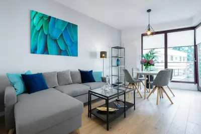 a living room with a couch and a table at Kopernika8 Miro Apartment with Balcony and AC in Kraków