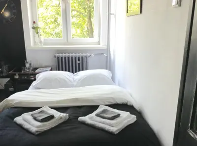 a bedroom with a bed with towels on it at Absolutely Apartment in Kraków