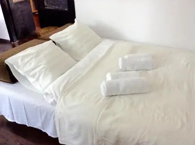 a white bed with towels on top of it at Absolutely Apartment in Kraków