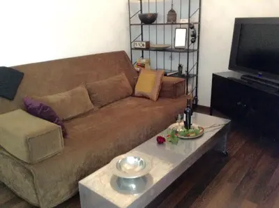 a living room with a couch and a coffee table at Absolutely Apartment in Kraków