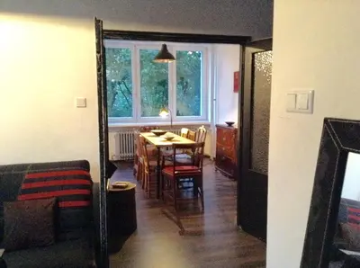 a living room with a table and a dining room at Absolutely Apartment in Kraków