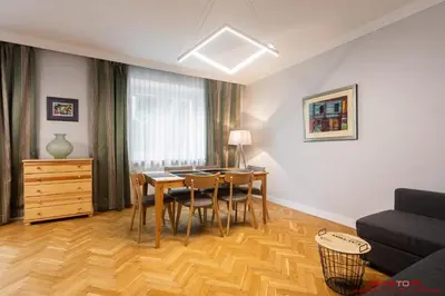 a living room with a table and chairs and a couch at Apartment Nearto Old Town Daszyńskiego street in Kraków