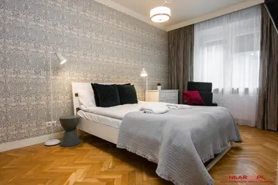 a bedroom with a large bed and a window at Apartment Nearto Old Town Daszyńskiego street in Kraków