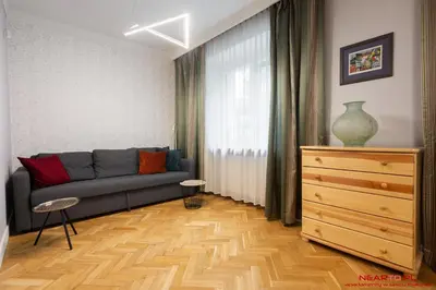 a living room with a couch and a dresser at Apartment Nearto Old Town Daszyńskiego street in Kraków
