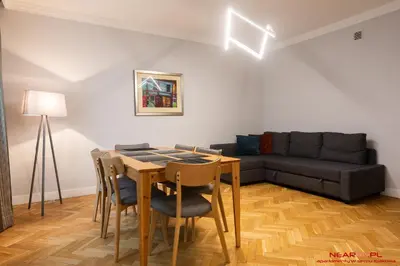 a living room with a table and a couch at Apartment Nearto Old Town Daszyńskiego street in Kraków