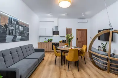 a living room with a couch and a table at Beautiful Cracow Apartments by Cozyplace in Kraków