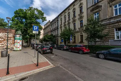 a street with cars parked on the side of the road at Beautiful Cracow Apartments by Cozyplace in Kraków
