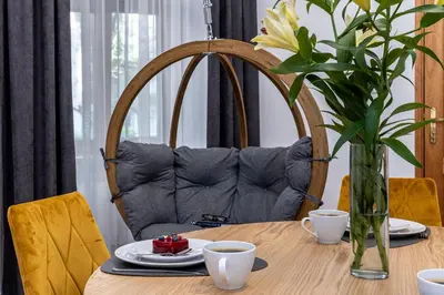 a dining room table with a mirror and a couch at Beautiful Cracow Apartments by Cozyplace in Kraków