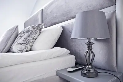 a lamp sitting on a table next to a couch at Elegant City Center Apartment Pawlikowskiego 8 in Kraków