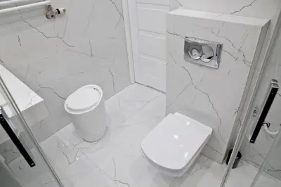 a white bathroom with a toilet and a sink at Elegant City Center Apartment Pawlikowskiego 8 in Kraków