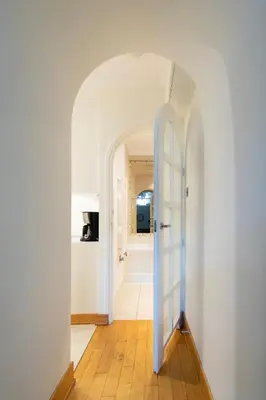 a hallway with a blue door leading into a room at Stylish 2 bedroom apartment Morsztynowska street in Kraków