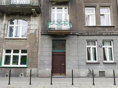 a building with a brown door and a balcony at Stylish 2 bedroom apartment Morsztynowska street in Kraków