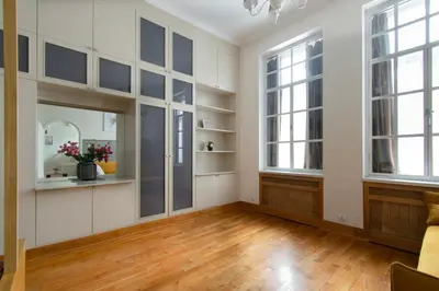 an empty living room with white walls and windows at Stylish 2 bedroom apartment Morsztynowska street in Kraków