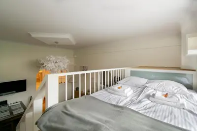 a bedroom with a white bed with two pillows at Stylish 2 bedroom apartment Morsztynowska street in Kraków