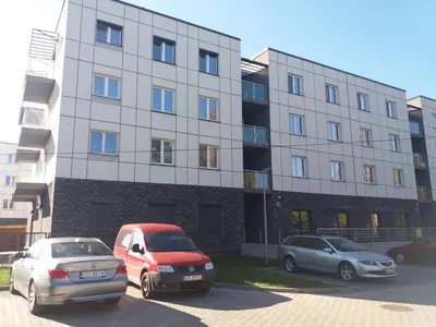 three cars parked in a parking lot in front of a building at Apartament FAMILY- klimatyzacja in Oświęcim