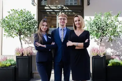 a man and two women standing in front of a building at Balthazar Design Hotel in Kraków