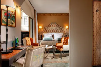 a hotel room with a bed and a desk at Balthazar Design Hotel in Kraków