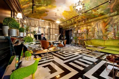 a lobby with a room with a ceiling with paintings at Balthazar Design Hotel in Kraków